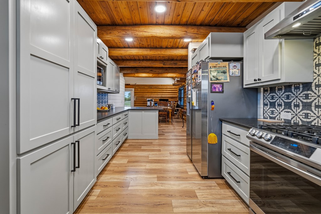 348 Blau Lane Hext, TX 76848 - Photo 13 of 94 a kitchen with stainless steel appliances granite countertop a stove and a refrigerator