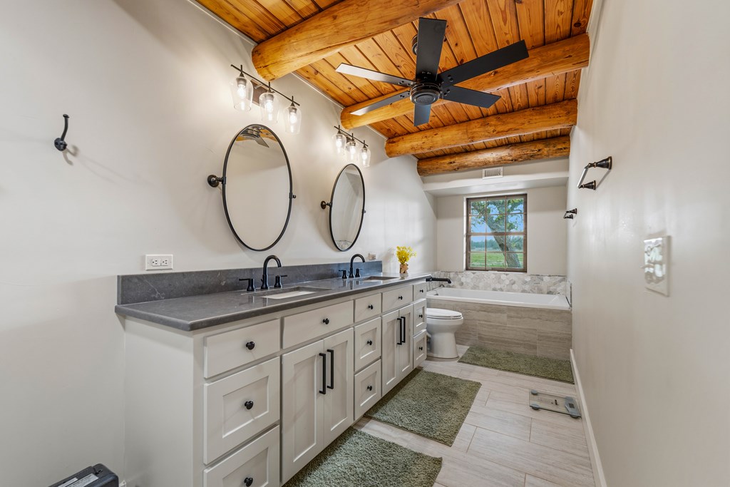 348 Blau Lane Hext, TX 76848 - Photo 24 of 94 a bathroom with a granite countertop sink a mirror and a shower