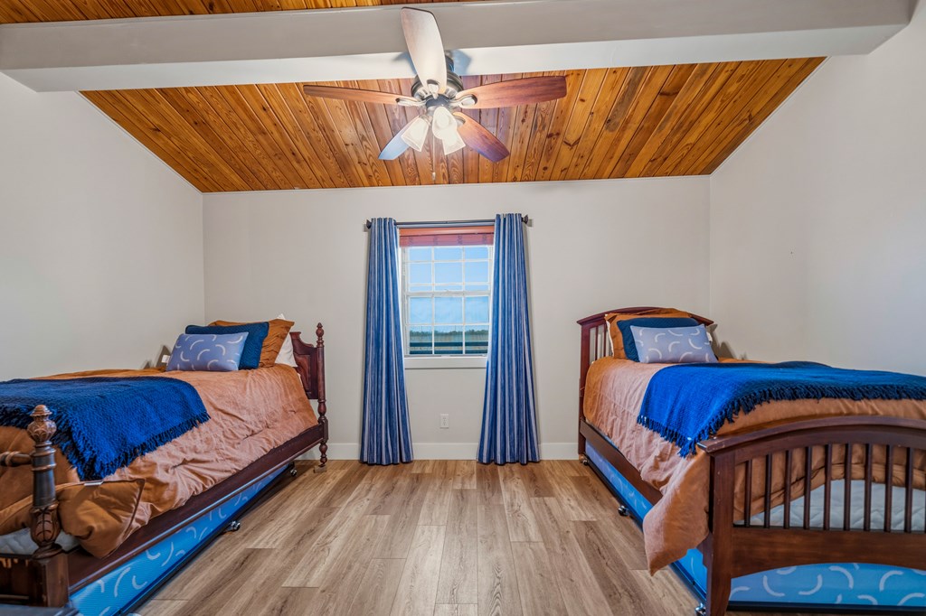 348 Blau Lane Hext, TX 76848 - Photo 26 of 94 a bedroom with a bed and wooden floor