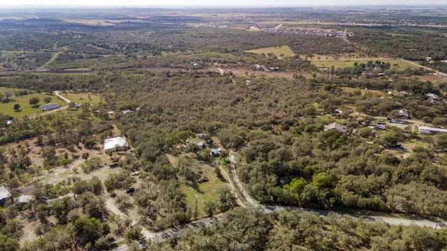 an aerial view of residential houses with city view