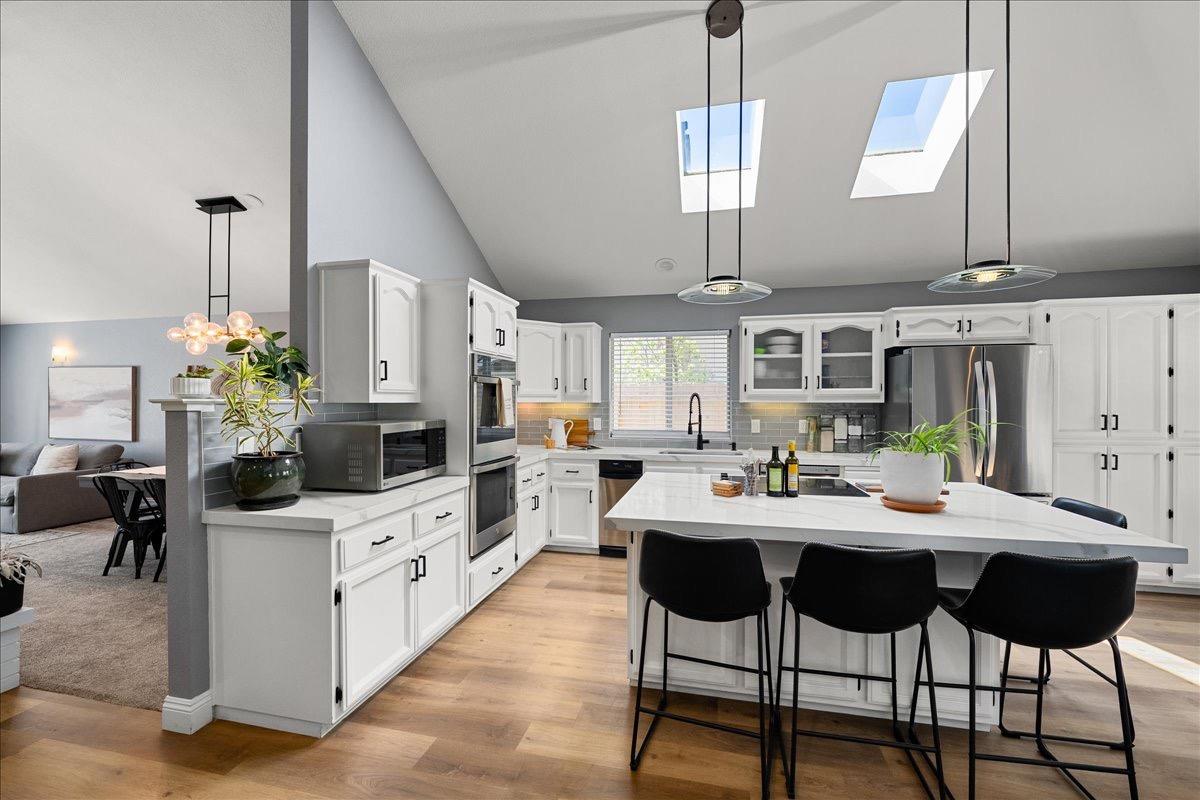 a kitchen with stainless steel appliances kitchen island granite countertop a sink and cabinets