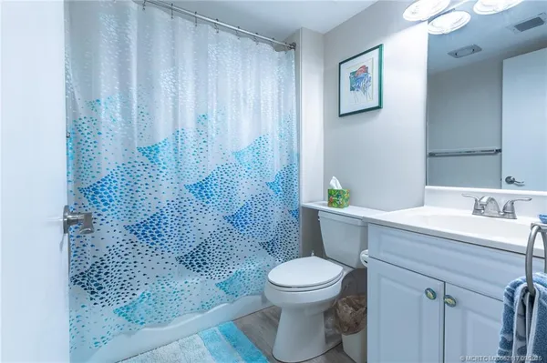 a view of a street with a cars parked in front of it