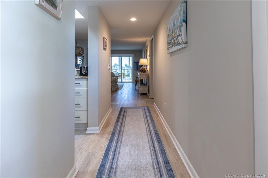 5596 Northeast Gulfstream Way Stuart, FL 34996 - Photo 3 of 21 a view of a hallway with wooden floor and staircase