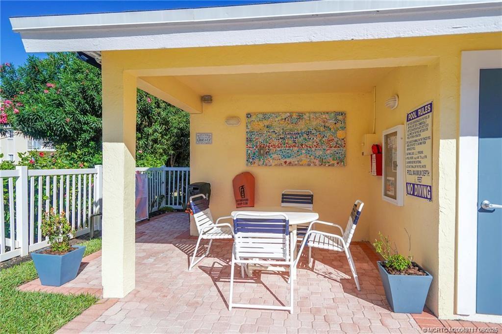 5596 Northeast Gulfstream Way Stuart, FL 34996 - Photo 7 of 21 a view of a balcony with chairs and a potted plant