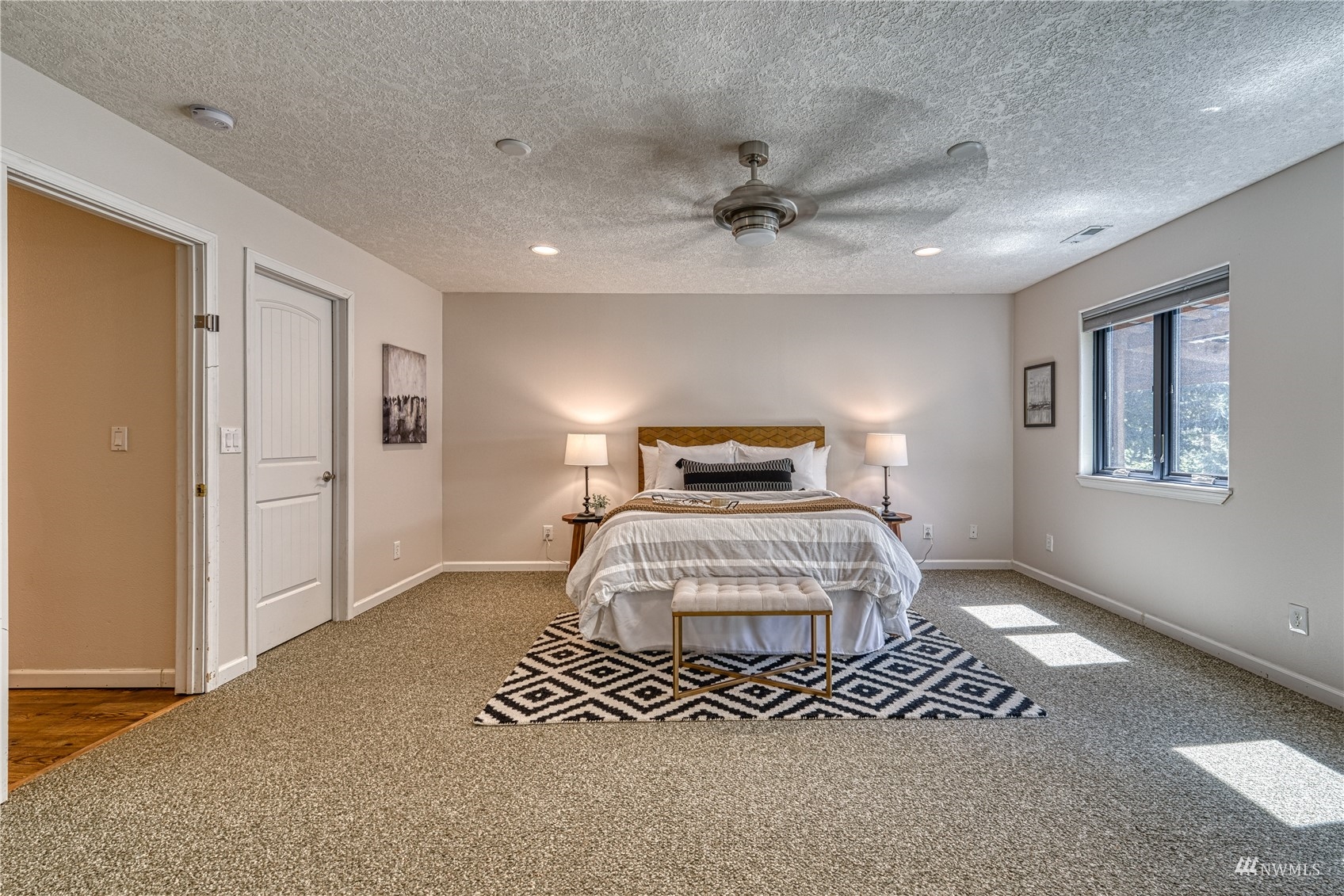 325 Hawkins Road Winlock, WA 98596 - Photo 16 of 40 a bedroom with a large bed and a chandelier