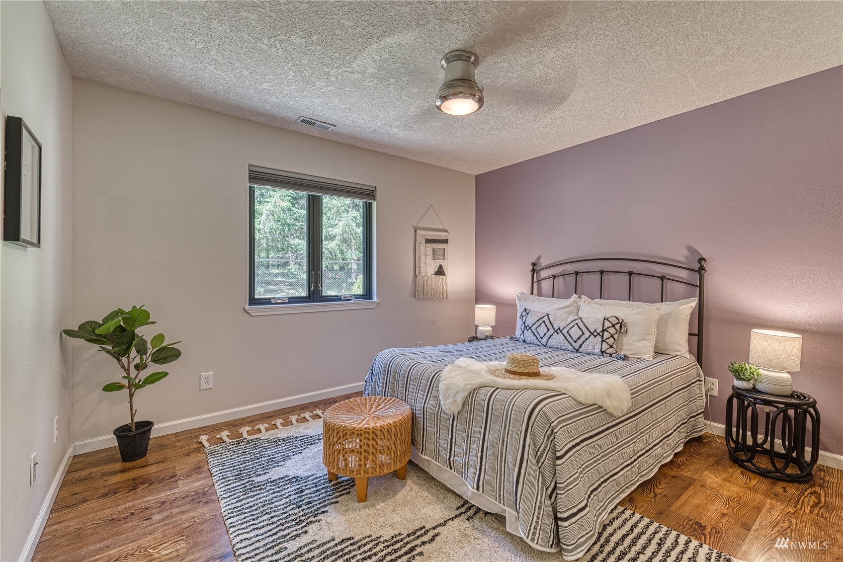 325 Hawkins Road Winlock, WA 98596 - Photo 20 of 40 a bedroom with a bed and wooden floor