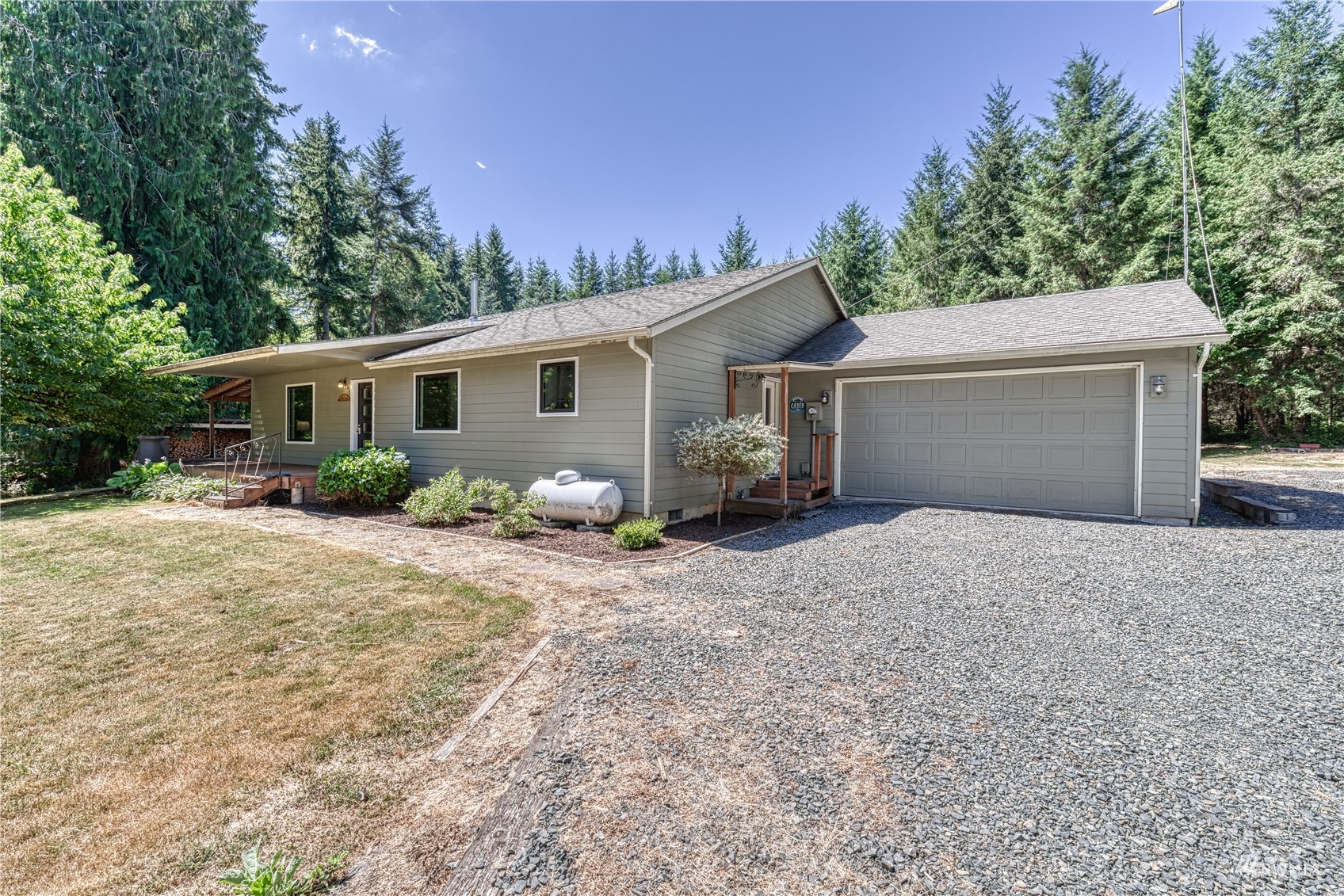 325 Hawkins Road Winlock, WA 98596 - Photo 3 of 40 a view of a house with backyard and trees in the background