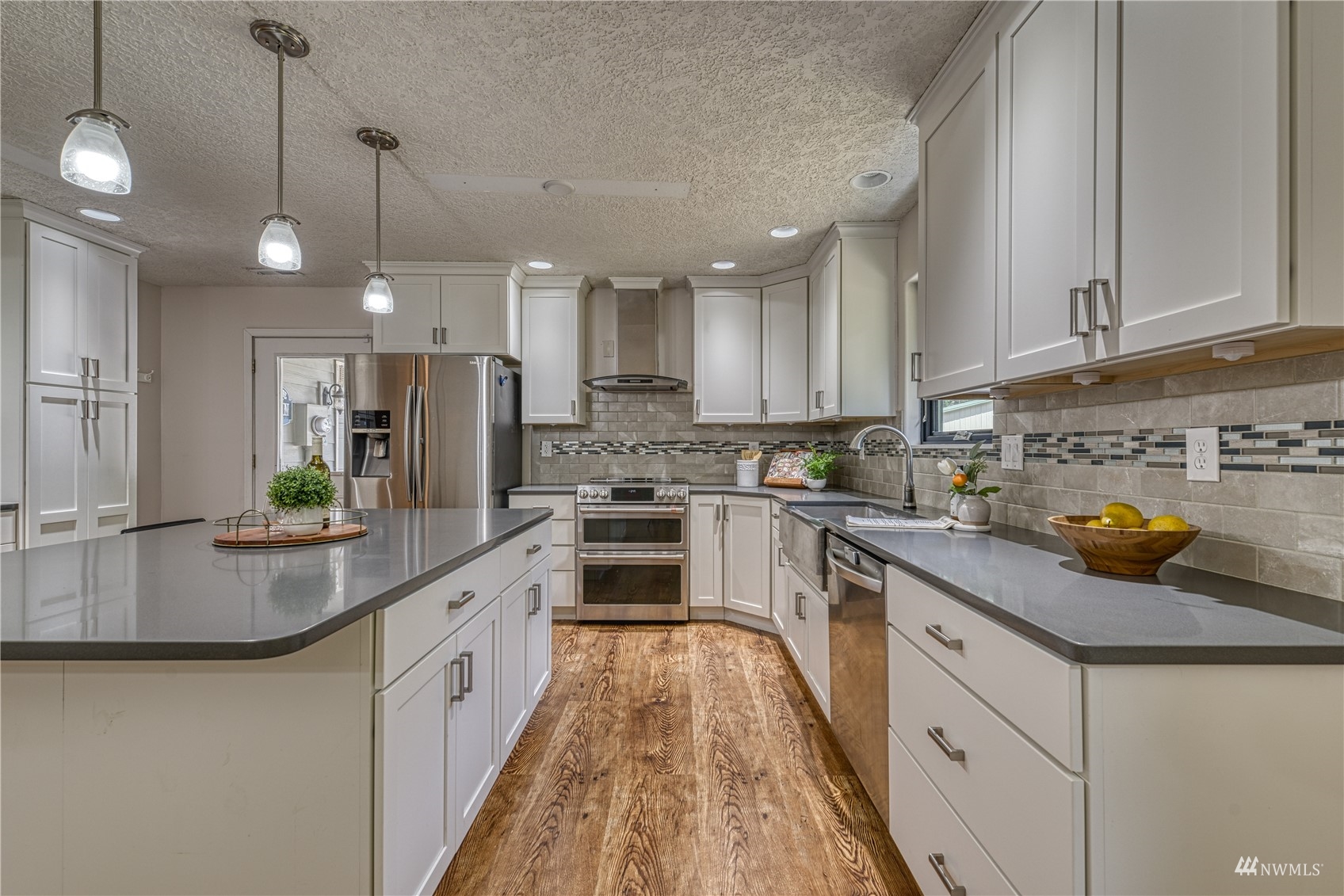 325 Hawkins Road Winlock, WA 98596 - Photo 7 of 40 a kitchen with kitchen island granite countertop a sink a counter space appliances and cabinets
