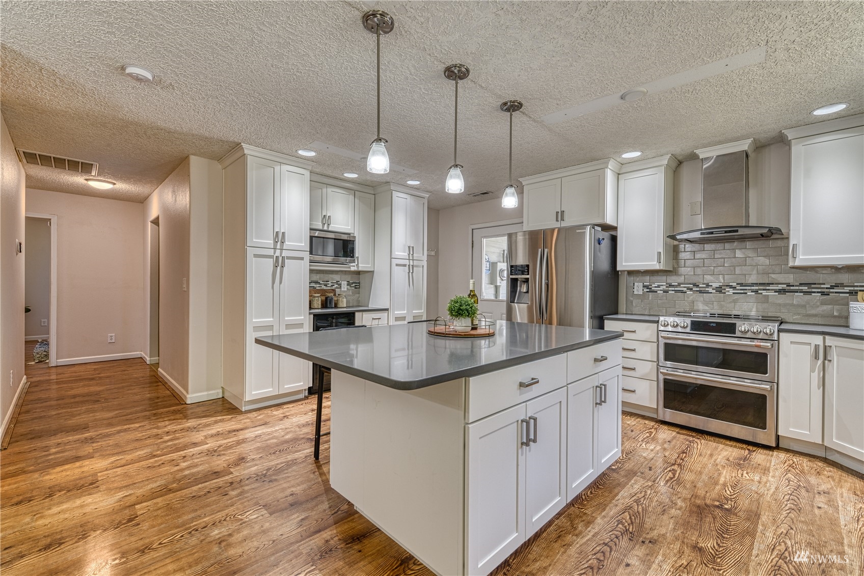 325 Hawkins Road Winlock, WA 98596 - Photo 8 of 40 a kitchen with stainless steel appliances kitchen island granite countertop a sink stove and refrigerator