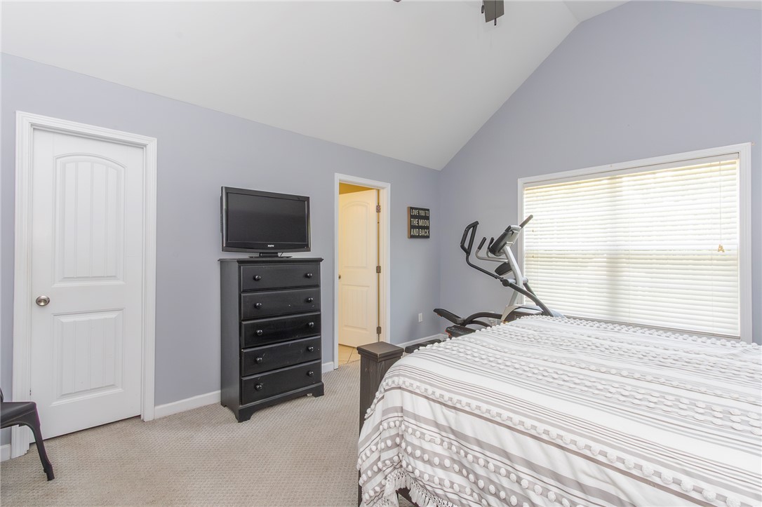861 North Old Pendleton Road Liberty, SC 29657 - Photo 19 of 45 A vaulted ceiling crowns this serene bedroom, featuring carpeted flooring and a broad window with blinds.