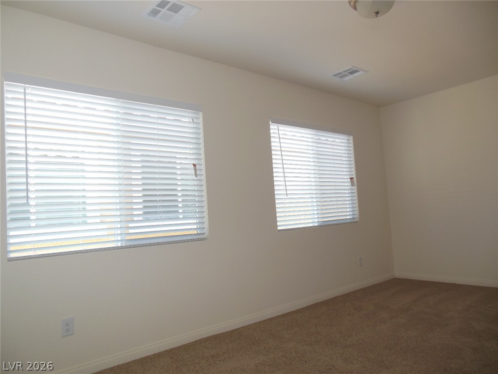 6390 Jackson Spring Road Las Vegas, NV 89118 - Photo 25 of 27 Two generous windows illuminate this inviting room, perfect for rest or relaxation.