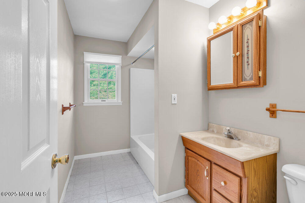 896 Anderson Road Jackson, NJ 08527 - Photo 18 of 21 a bathroom with a sink a vanity and a mirror