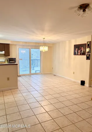 a kitchen with stainless steel appliances granite countertop a stove a sink dishwasher and white cabinets with wooden floor