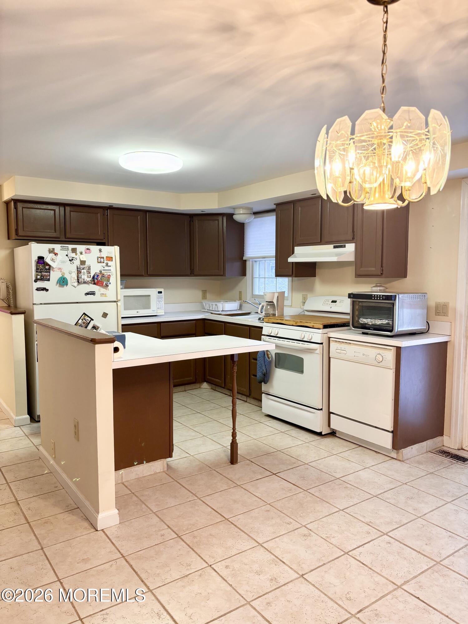 896 Anderson Road Jackson, NJ 08527 - Photo 6 of 21 a kitchen with stainless steel appliances granite countertop a stove a sink dishwasher and white cabinets with wooden floor
