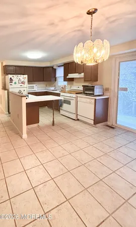 a kitchen with stainless steel appliances a sink a stove a microwave a counter top space and cabinets