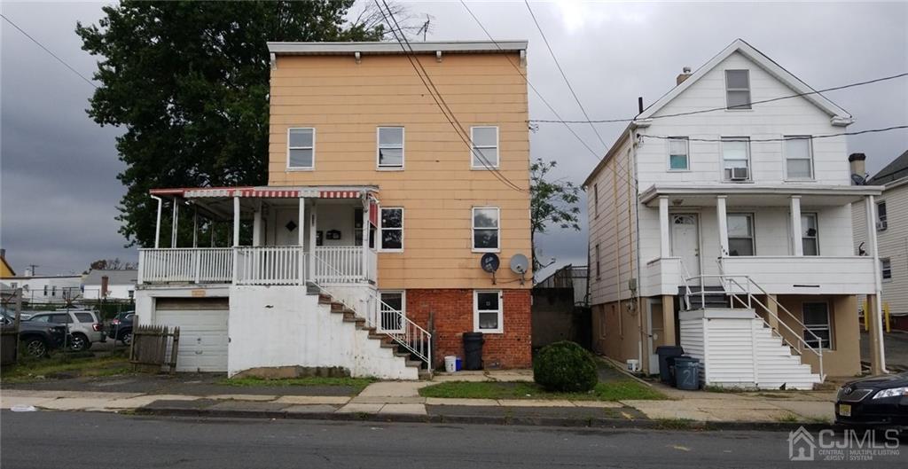 136 Broad Street Perth Amboy, NJ 08861 - Photo 2 of 10 a front view of a house with a yard