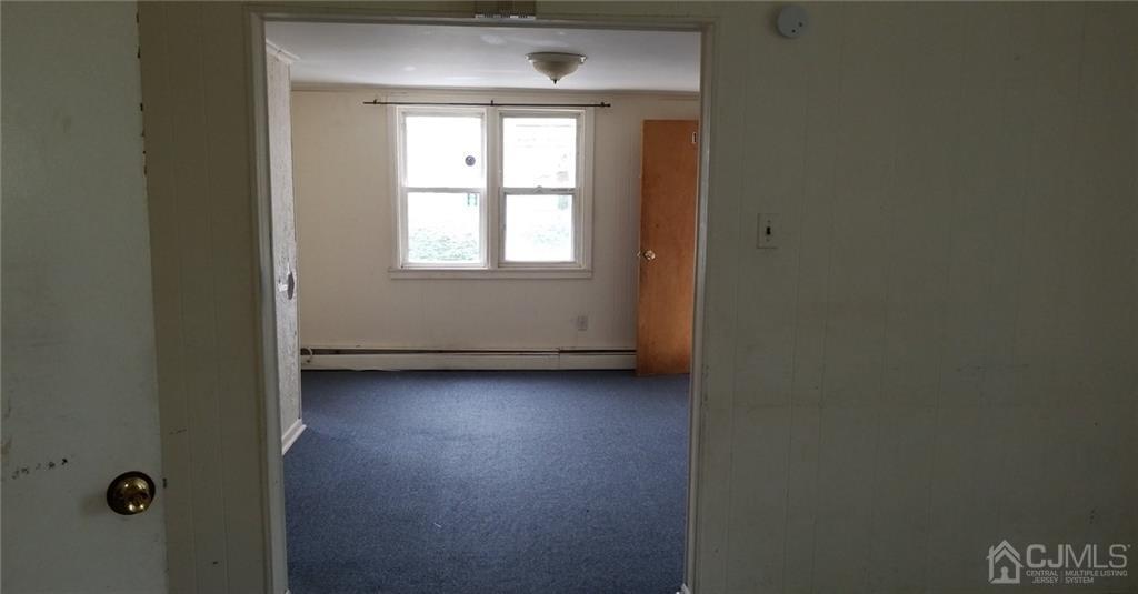 136 Broad Street Perth Amboy, NJ 08861 - Photo 4 of 10 an empty room with a window
