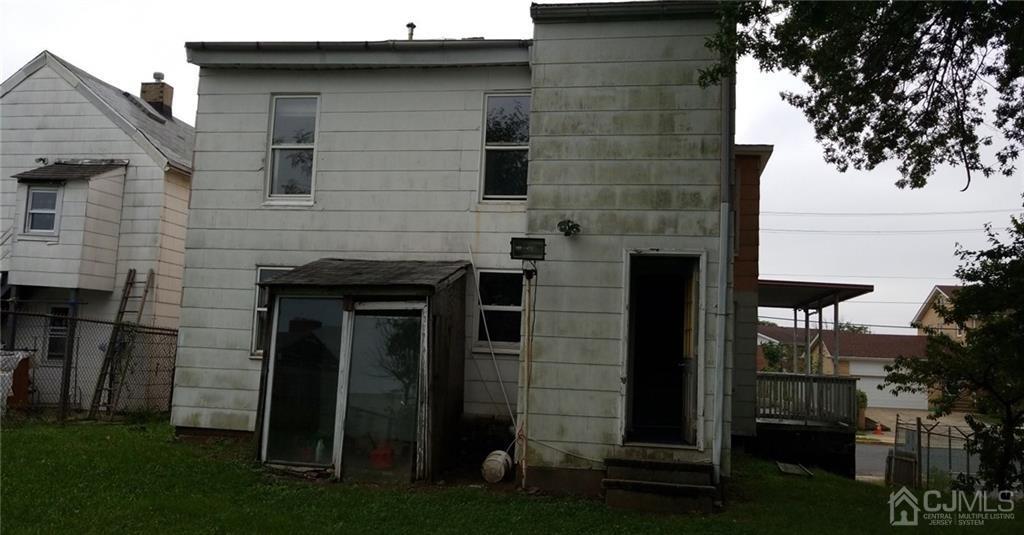 136 Broad Street Perth Amboy, NJ 08861 - Photo 7 of 10 a front view of a house with a garden