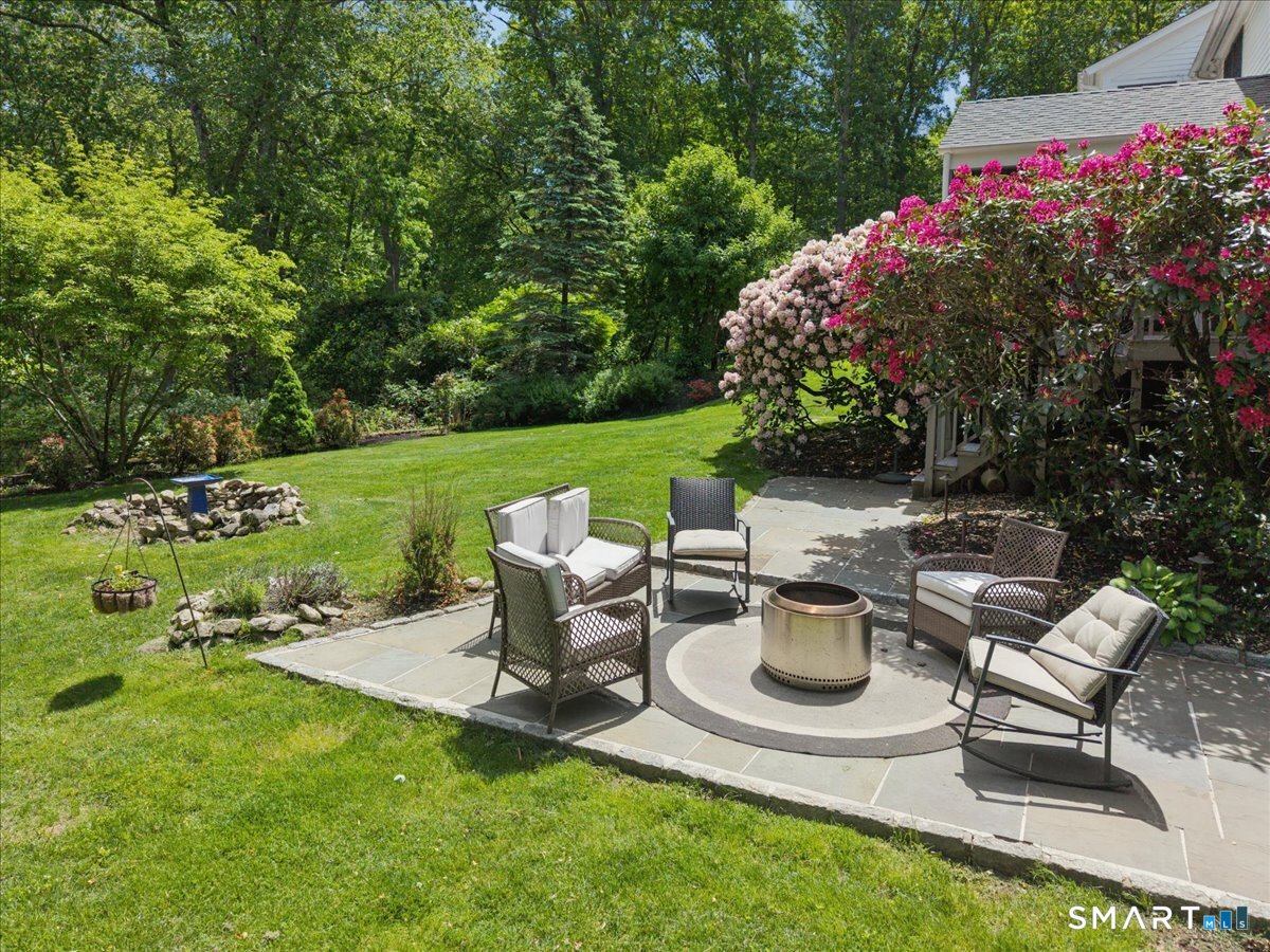 94 Vista Road Wilton, CT 06897 - Photo 34 of 38 a view of a backyard with sitting area and garden