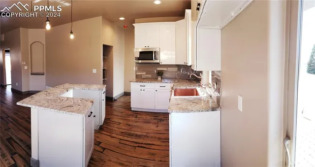 a open kitchen view with cabinets a sink and a stove