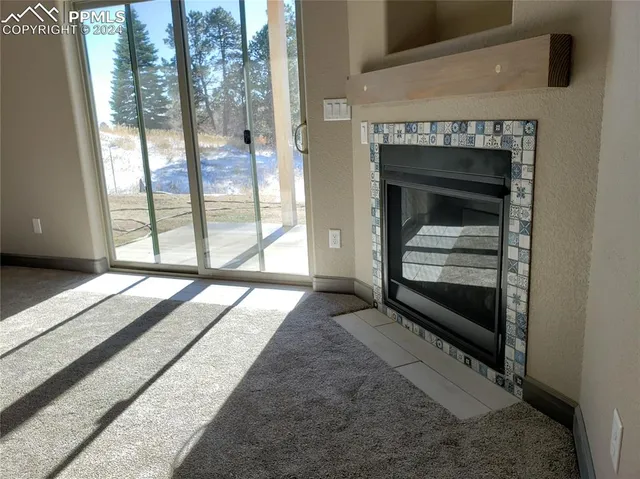 a view of a hallway with wooden floor and a bathroom
