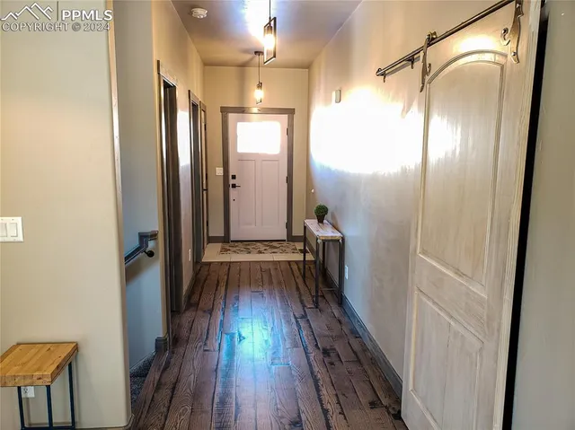 a bathroom with a granite countertop sink a toilet a window and vanity