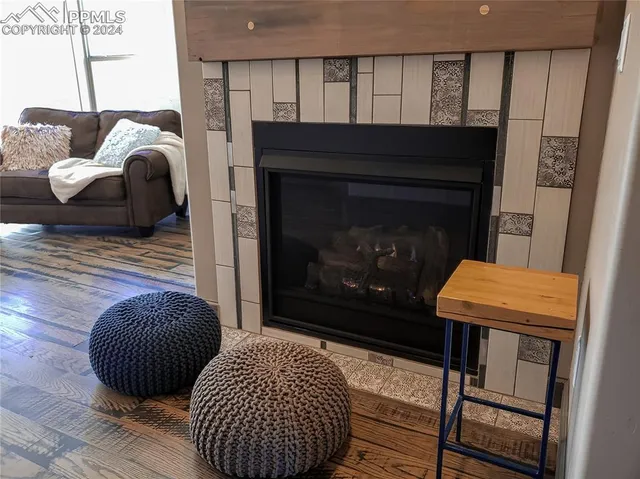 a kitchen with stainless steel appliances granite countertop a stove a refrigerator a sink and a oven with wooden floor