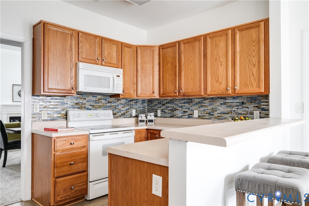 2209 Magnolia Grove Way Midlothian, VA 23113 - Photo 12 of 50 a kitchen with stainless steel appliances granite countertop a sink stove and cabinets