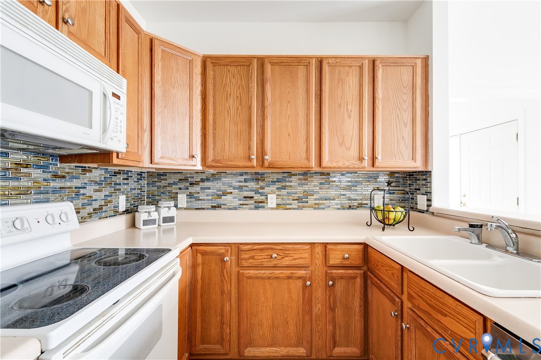2209 Magnolia Grove Way Midlothian, VA 23113 - Photo 14 of 50 a kitchen with stainless steel appliances granite countertop a sink and a cabinets