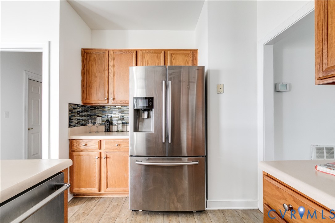 2209 Magnolia Grove Way Midlothian, VA 23113 - Photo 15 of 50 a kitchen with a refrigerator a stove top oven a washer and dryer