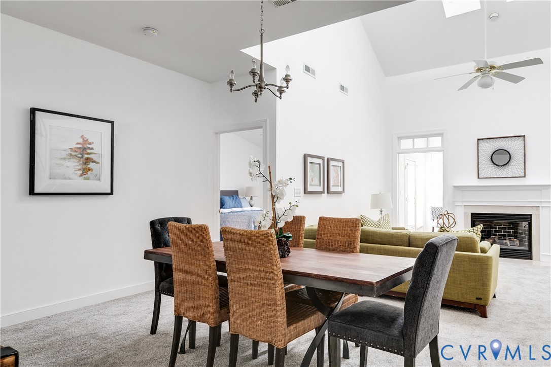 2209 Magnolia Grove Way Midlothian, VA 23113 - Photo 17 of 50 a dining room with furniture a chandelier and wooden floor