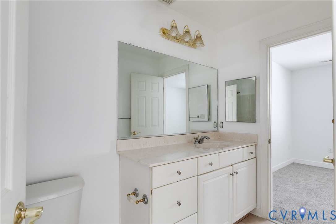 2209 Magnolia Grove Way Midlothian, VA 23113 - Photo 44 of 50 a bathroom with a sink and a mirror