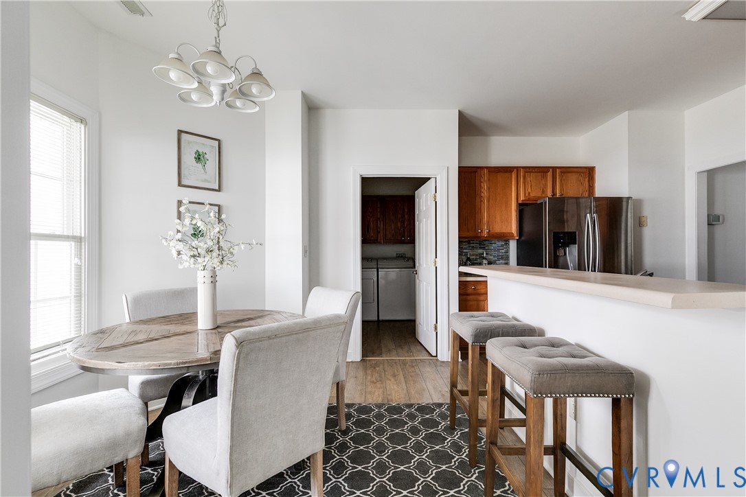 2209 Magnolia Grove Way Midlothian, VA 23113 - Photo 7 of 50 a living room with furniture a chandelier and a dining room