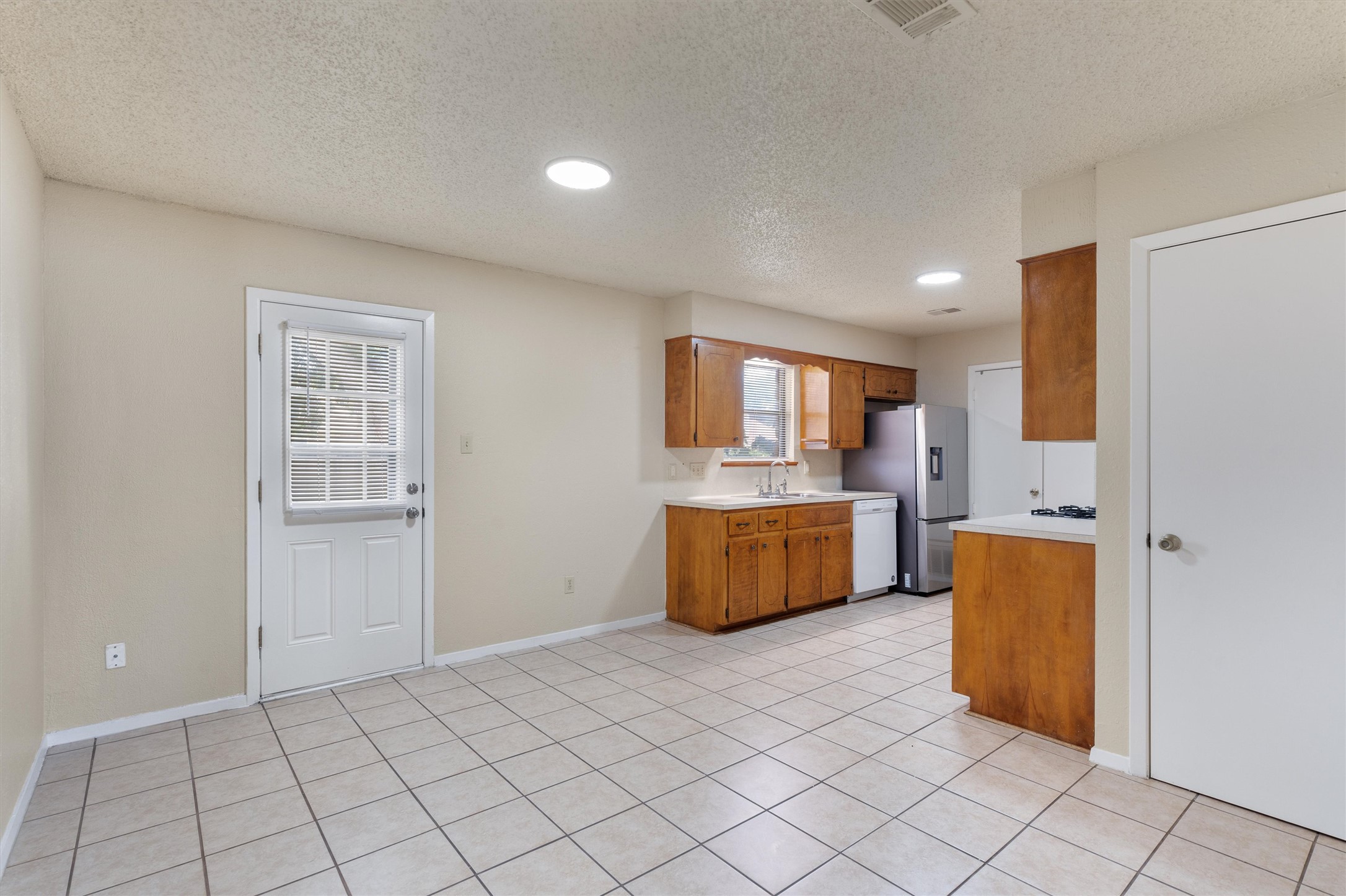 2805 Davis Street, Unit A Taylor, TX 76574 - Photo 4 of 12 a kitchen with stainless steel appliances a refrigerator and a stove top oven
