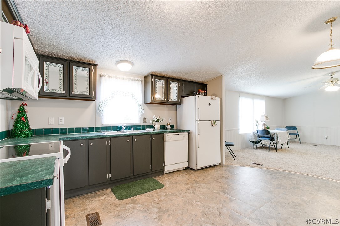 3464 Cedar Plains Road Sandy Hook, VA 23153 - Photo 19 of 43 a kitchen with refrigerator and chairs