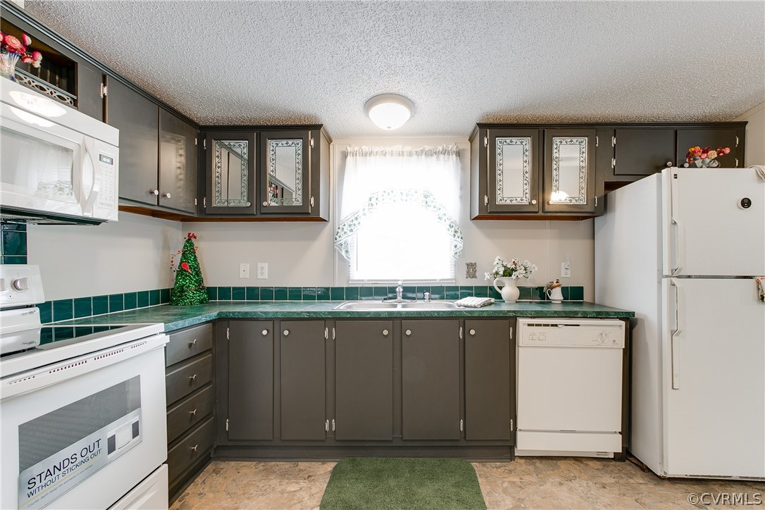 3464 Cedar Plains Road Sandy Hook, VA 23153 - Photo 20 of 43 a kitchen with granite countertop a sink stainless steel appliances and white cabinets