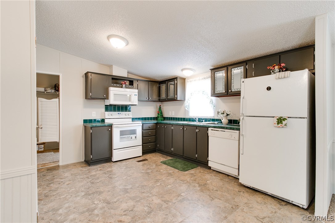 3464 Cedar Plains Road Sandy Hook, VA 23153 - Photo 21 of 43 a kitchen with a refrigerator a sink and a stove