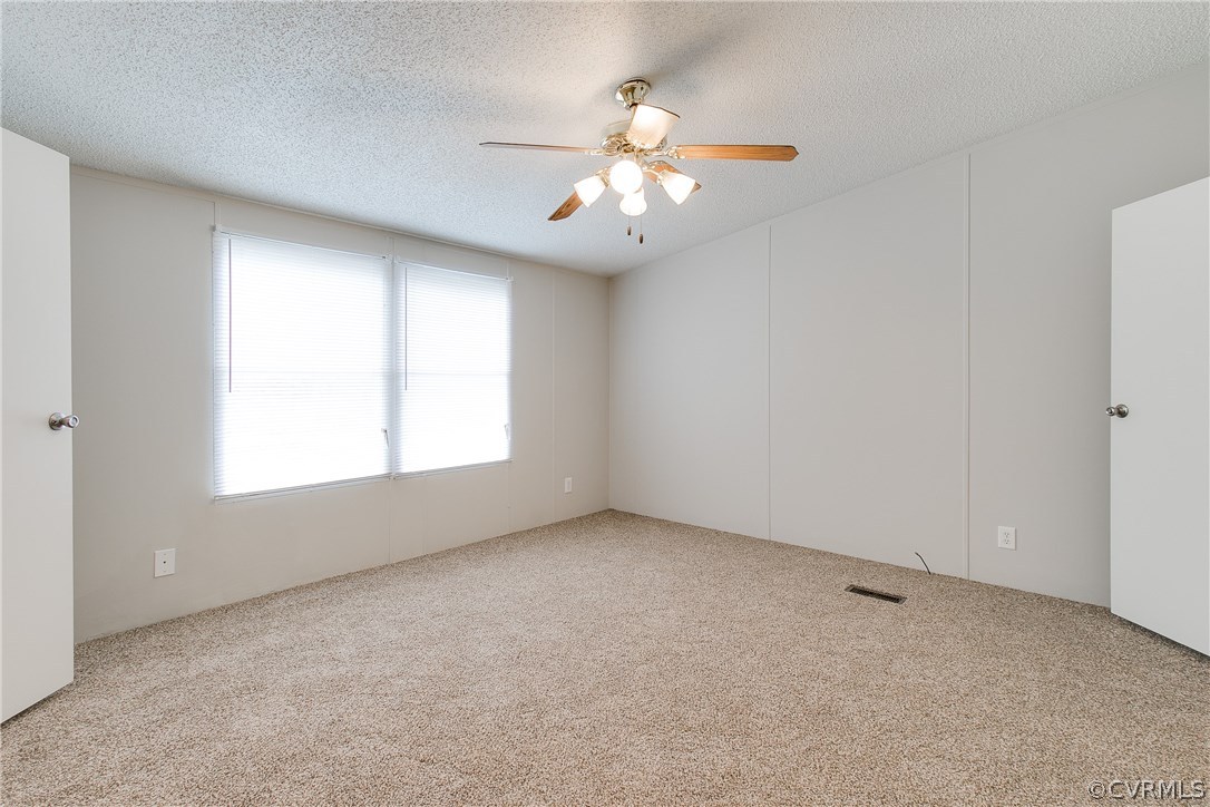 3464 Cedar Plains Road Sandy Hook, VA 23153 - Photo 24 of 43 an empty room with windows and ceiling fan