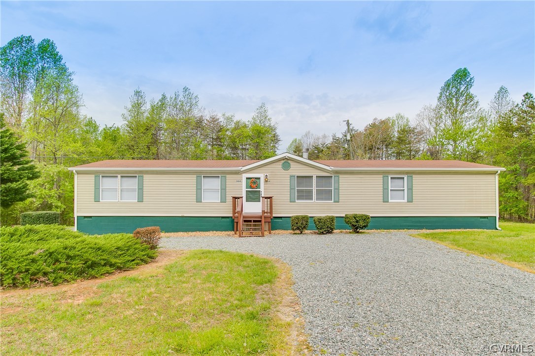 3464 Cedar Plains Road Sandy Hook, VA 23153 - Photo 3 of 43 a front view of a house with a yard and garage
