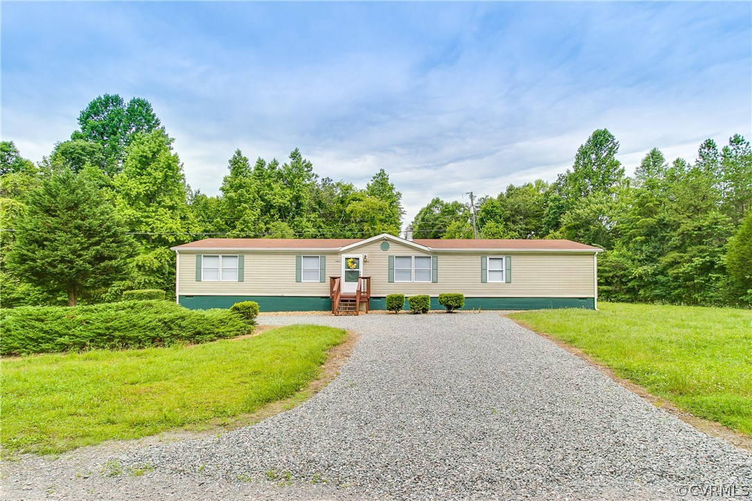 3464 Cedar Plains Road Sandy Hook, VA 23153 - Photo 4 of 43 a front view of a house with a yard and garage