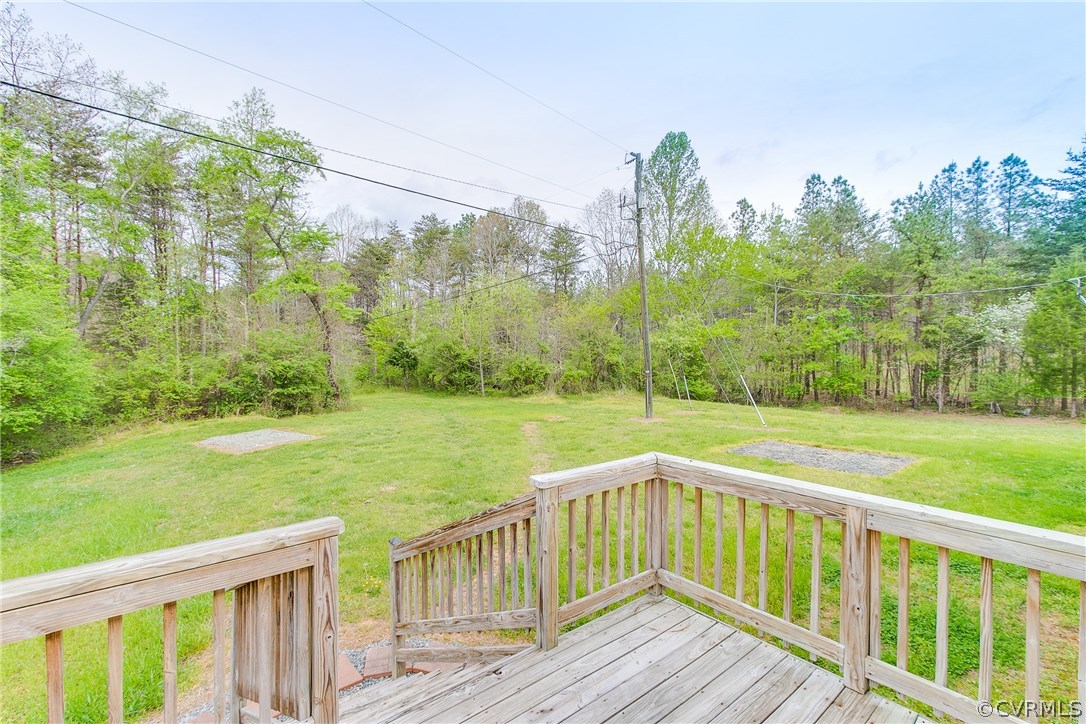 3464 Cedar Plains Road Sandy Hook, VA 23153 - Photo 42 of 43 a view of a wooden deck and a yard with swimming pool in front of house