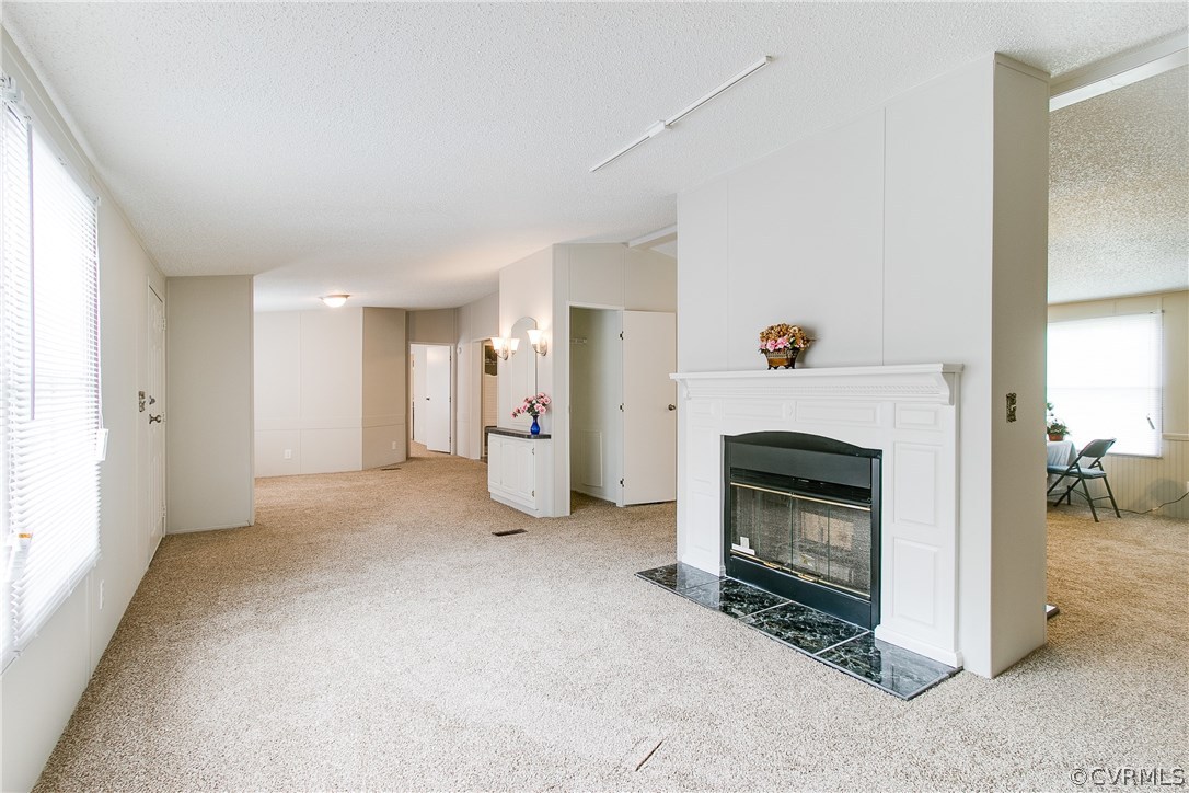 3464 Cedar Plains Road Sandy Hook, VA 23153 - Photo 7 of 43 a view of a livingroom with a fireplace and a window