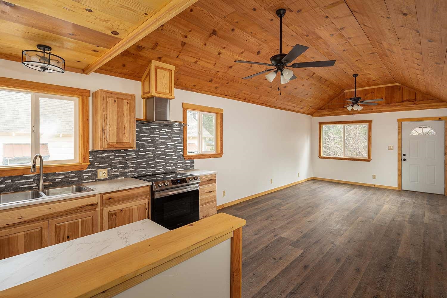 318 Coates Avenue Calpine, CA 96124 - Photo 5 of 21 a kitchen with granite countertop a sink stainless steel appliances wooden floor and cabinets