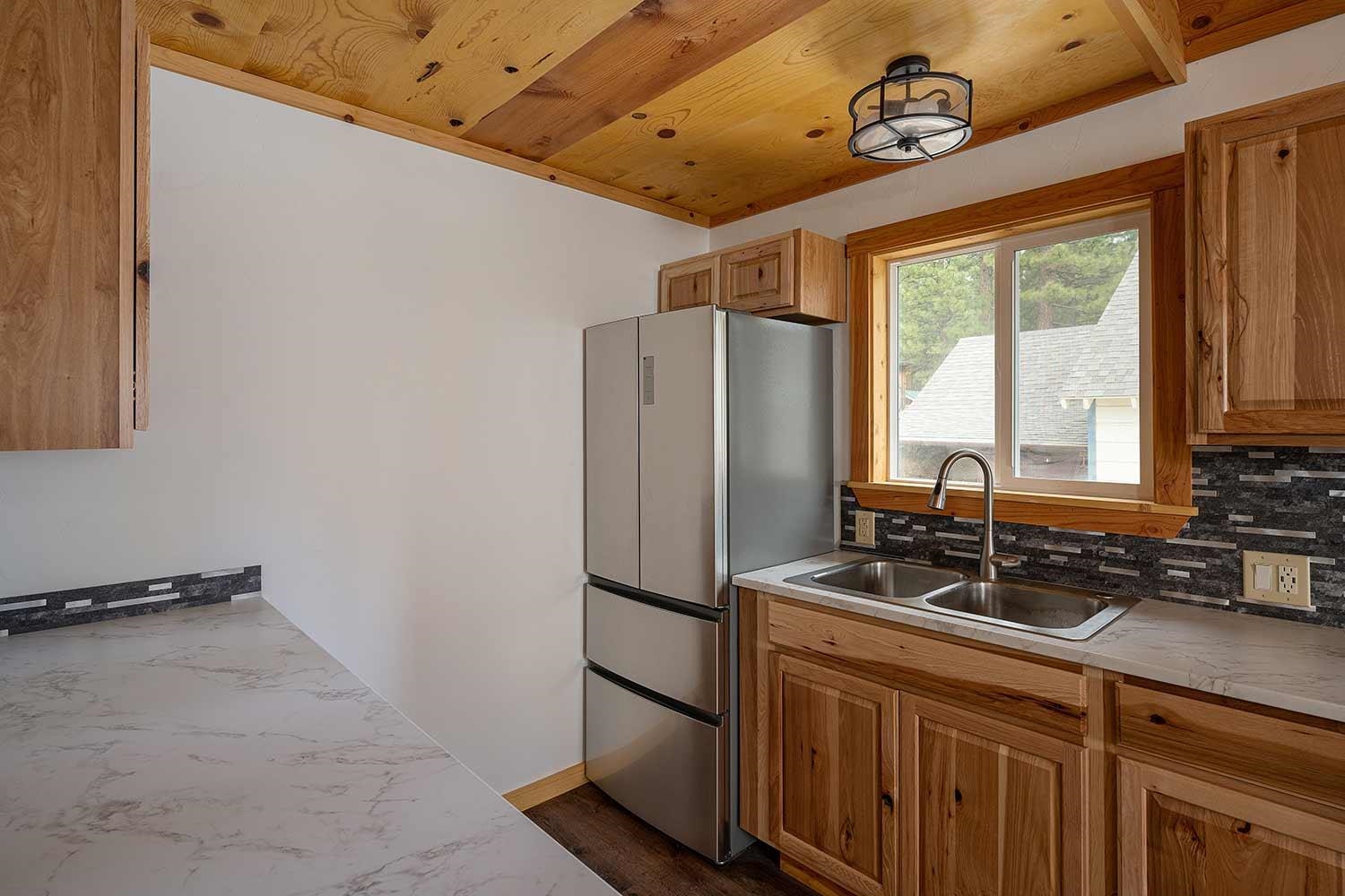 318 Coates Avenue Calpine, CA 96124 - Photo 9 of 21 a kitchen with stainless steel appliances a refrigerator and a sink