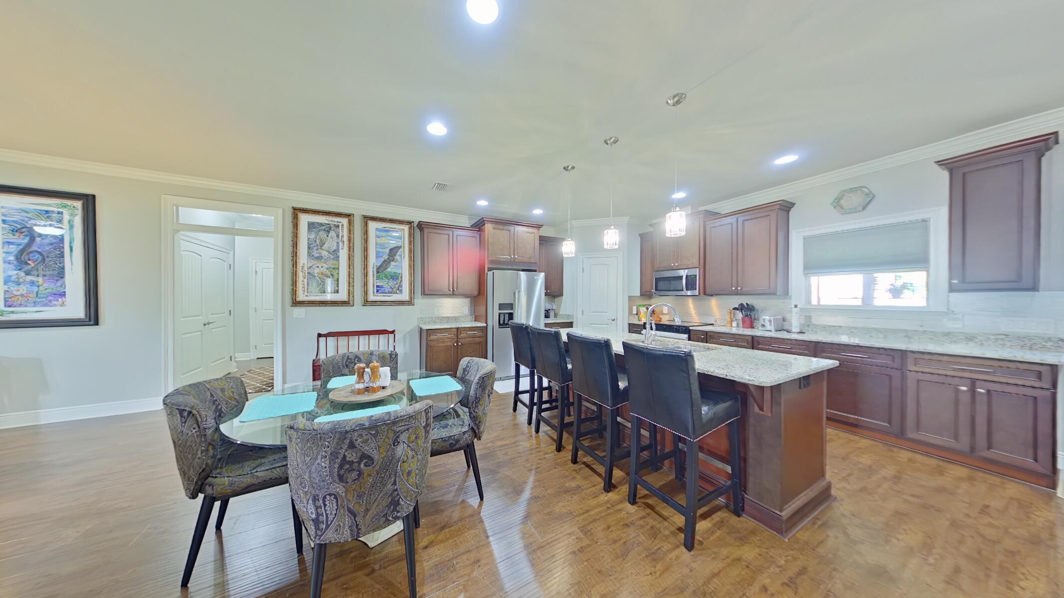 8686 El Paseo Street Navarre, FL 32566 - Photo 11 of 39 a kitchen with a dining table chairs and view kitchen