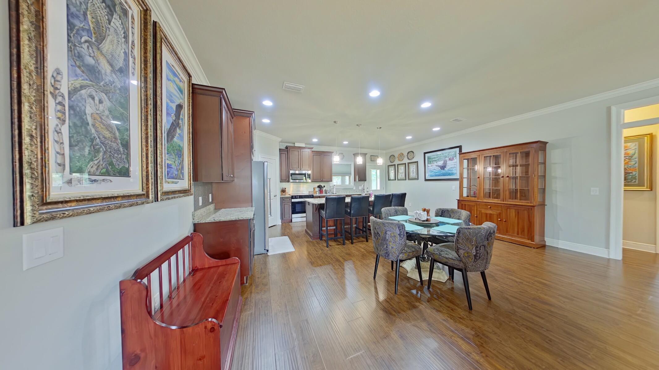 8686 El Paseo Street Navarre, FL 32566 - Photo 12 of 39 a view of a dining room with furniture and wooden floor