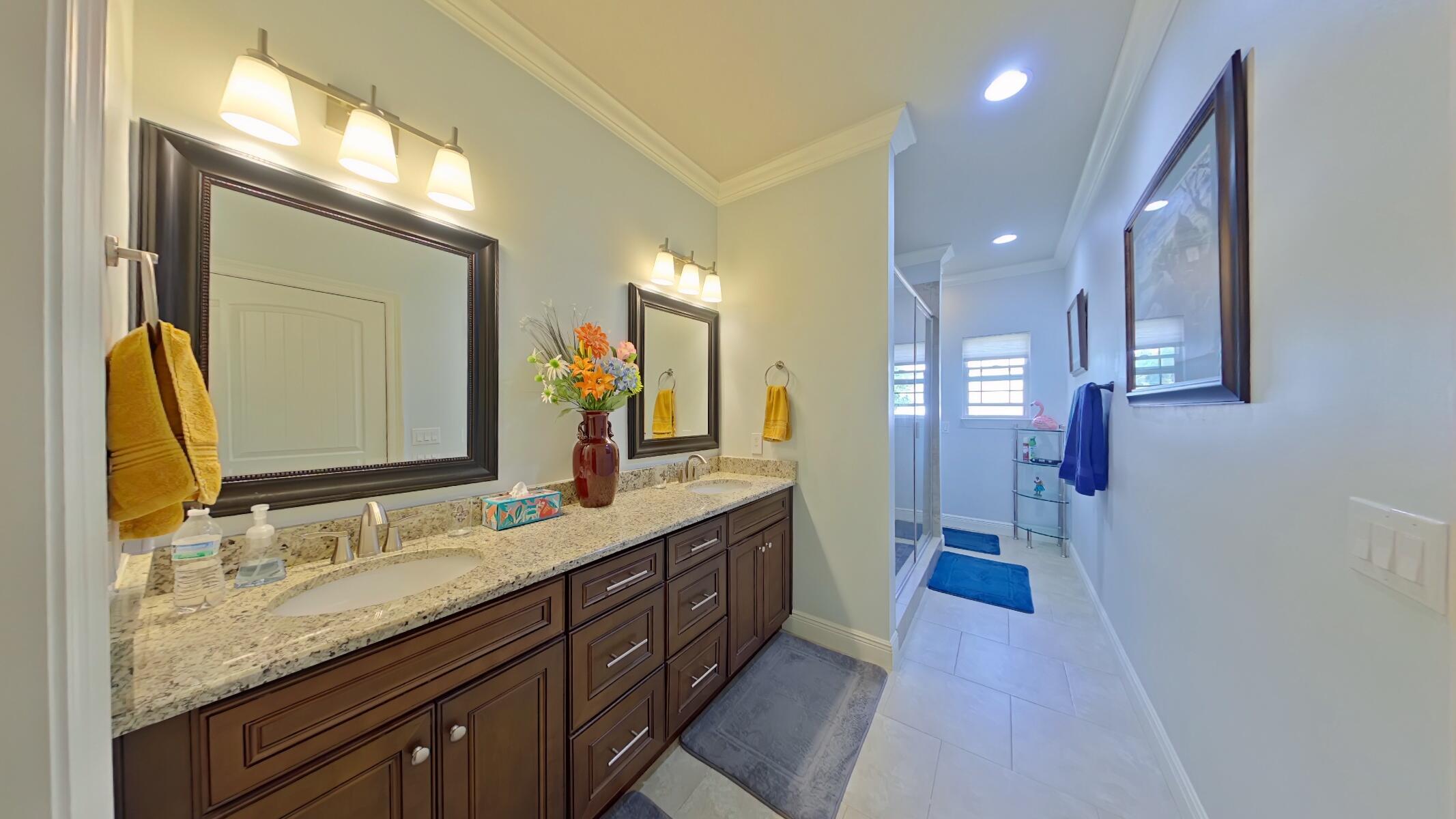 8686 El Paseo Street Navarre, FL 32566 - Photo 16 of 39 a bathroom with a granite countertop double vanity sink and a mirror