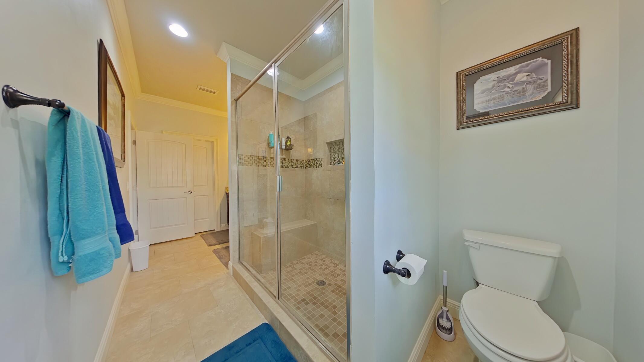 8686 El Paseo Street Navarre, FL 32566 - Photo 17 of 39 a bathroom with a toilet and a shower