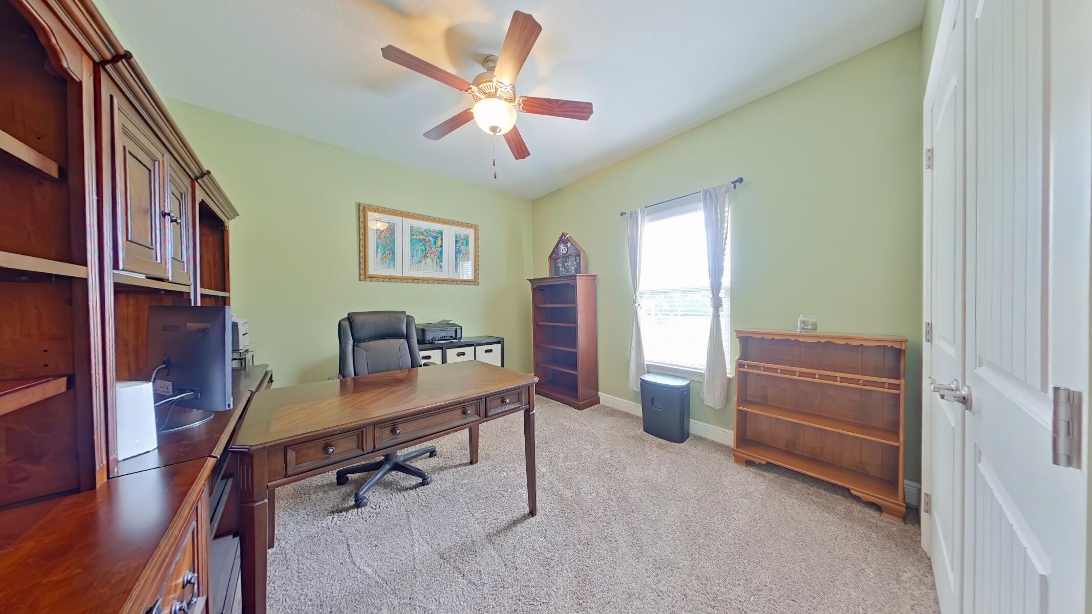 8686 El Paseo Street Navarre, FL 32566 - Photo 19 of 39 a view of a workspace with furniture and a window