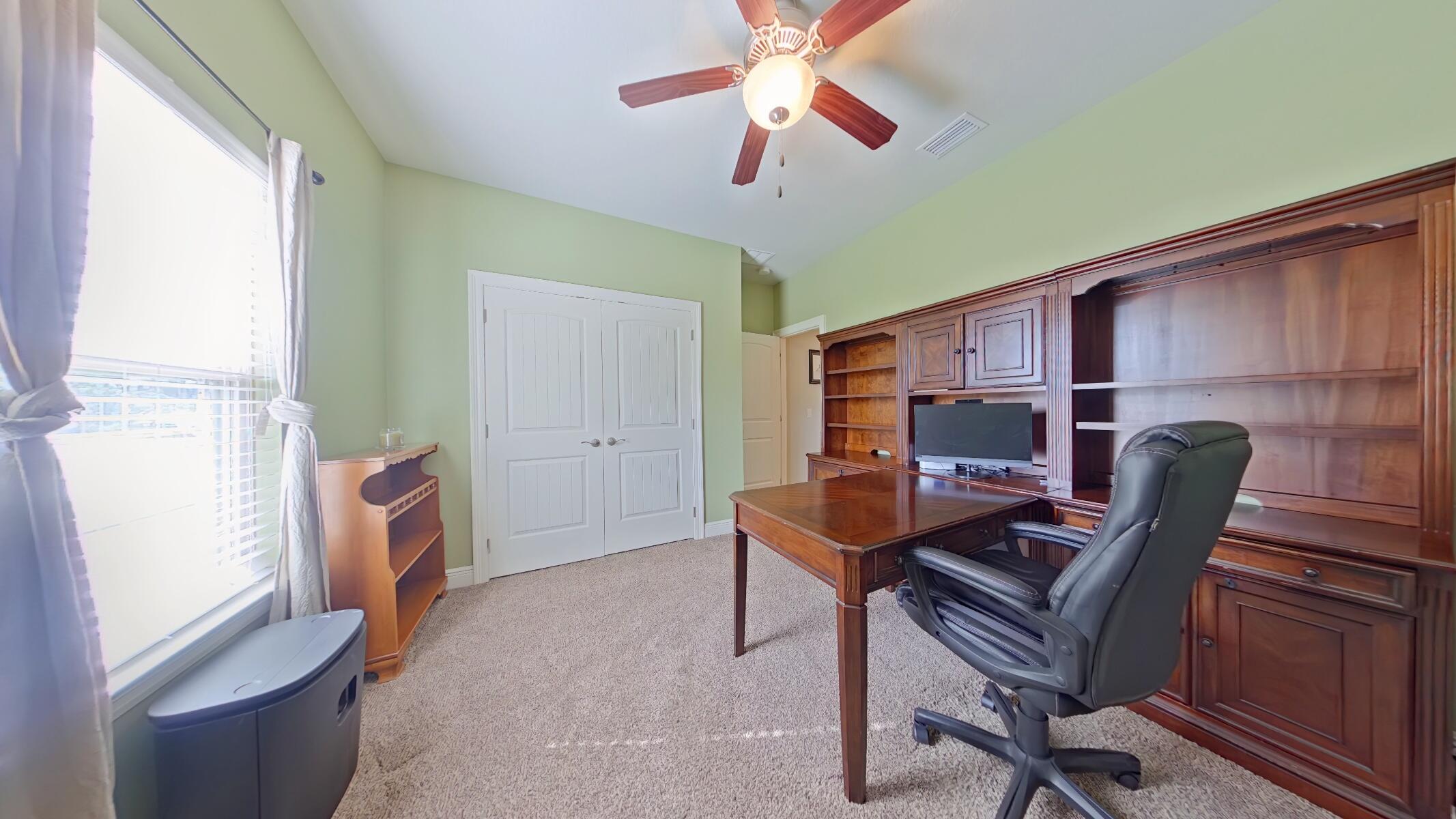 8686 El Paseo Street Navarre, FL 32566 - Photo 20 of 39 a workspace with furniture and a window